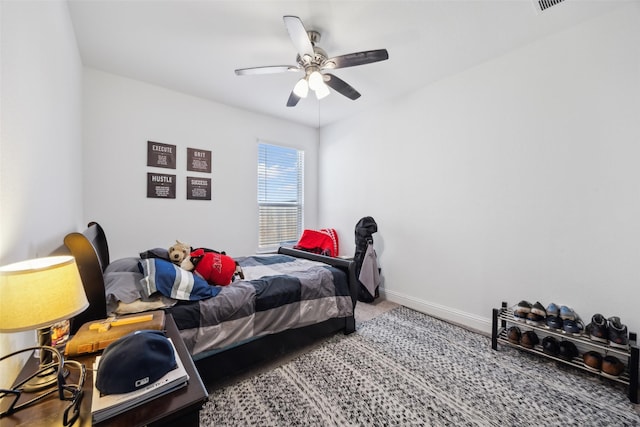 bedroom with baseboards, carpet, and a ceiling fan