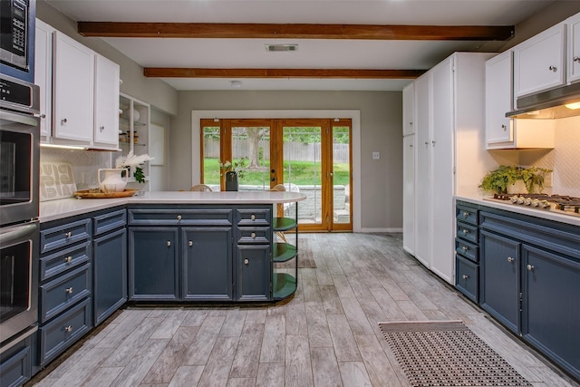 1311 Cedar Hill Ave, Dallas, TX 75208 - kitchen featuring white cabinetry, french doors, blue cabinetry, a peninsula, and beamed ceiling