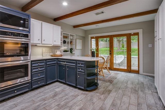 1311 Cedar Hill Ave, Dallas, TX 75208 - kitchen featuring open shelves, appliances with stainless steel finishes, beamed ceiling, white cabinets, and french doors