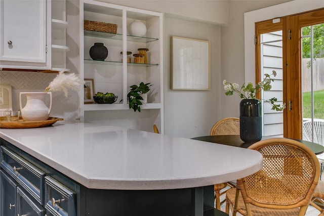 1311 Cedar Hill Ave, Dallas, TX 75208 - kitchen with open shelves, decorative backsplash, light countertops, and white cabinets