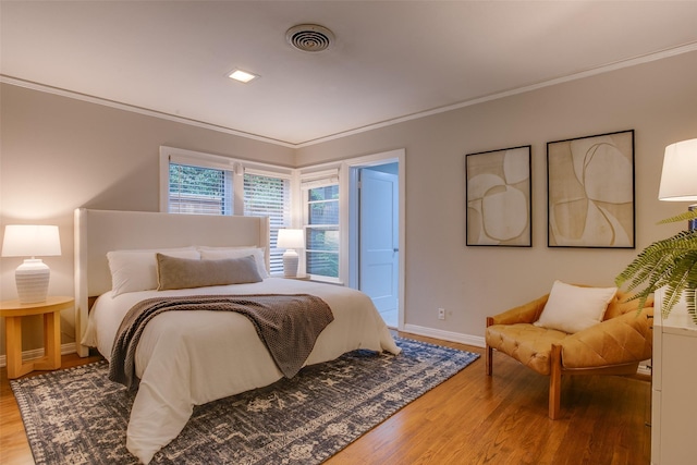 1311 Cedar Hill Ave, Dallas, TX 75208 - bedroom with wood finished floors, crown molding, and baseboards