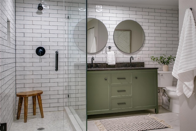 1311 Cedar Hill Ave, Dallas, TX 75208 - bathroom featuring tile walls, a stall shower, toilet, double vanity, and marble finish flooring