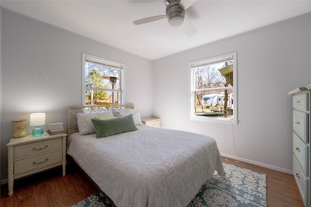 bedroom featuring a ceiling fan, wood finished floors, and baseboards