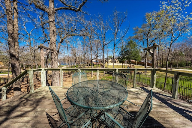 wooden terrace with outdoor dining space
