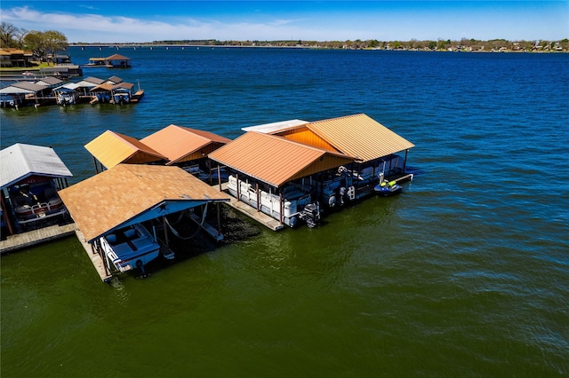 dock area with boat lift and a water view