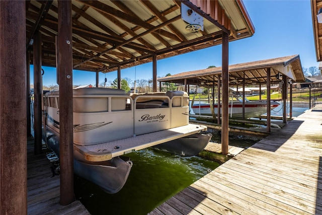dock area with a water view and boat lift