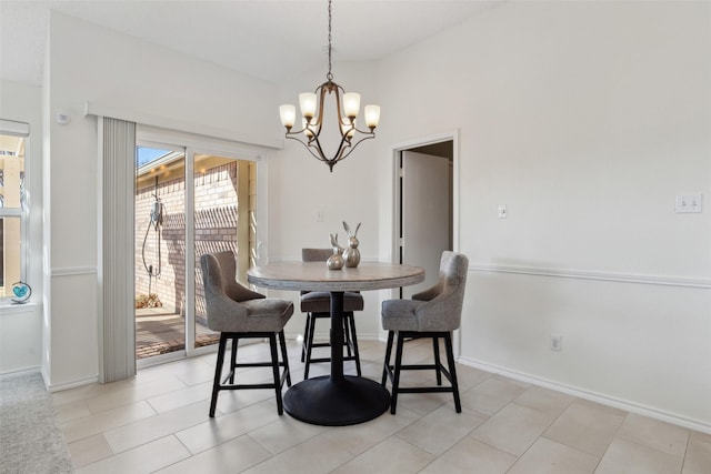 dining area featuring a notable chandelier and baseboards