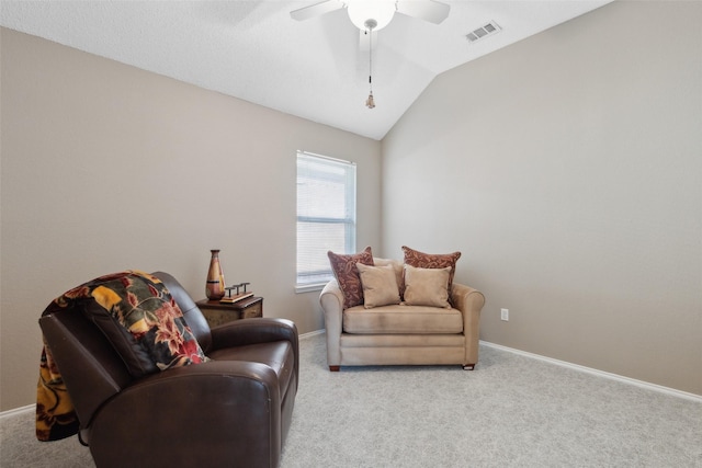 living area featuring visible vents, light colored carpet, and vaulted ceiling