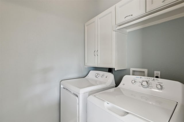 laundry room with cabinet space and washing machine and clothes dryer