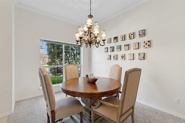 dining room with an inviting chandelier, carpet, and baseboards