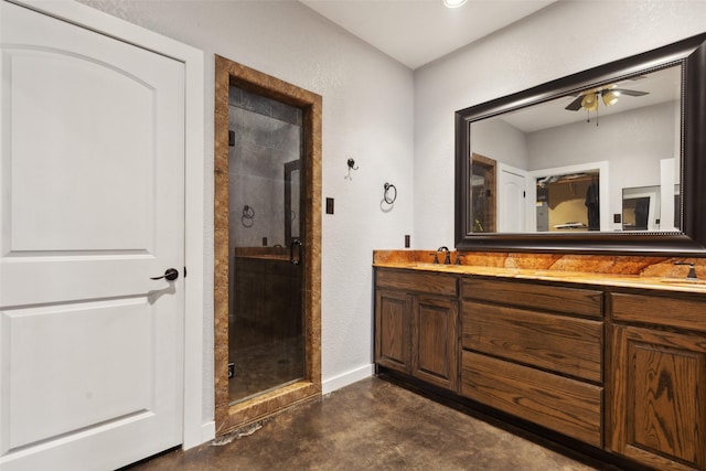 bathroom with a sink, concrete floors, a shower stall, and double vanity