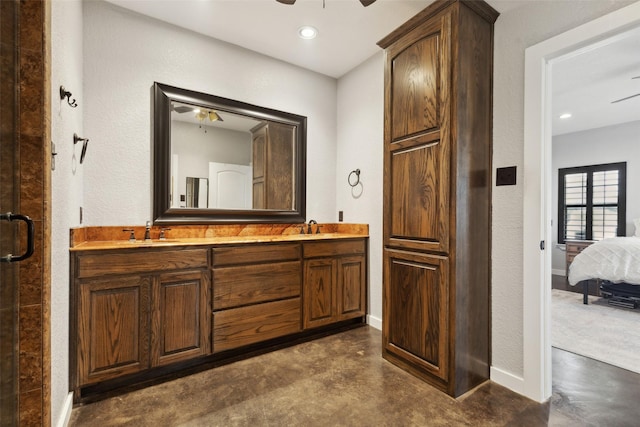 full bathroom with finished concrete flooring, a ceiling fan, and a sink