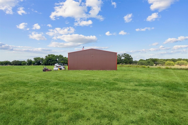 view of yard featuring a rural view, an outdoor structure, and a pole building