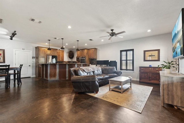 living room featuring visible vents, recessed lighting, baseboards, concrete flooring, and ceiling fan