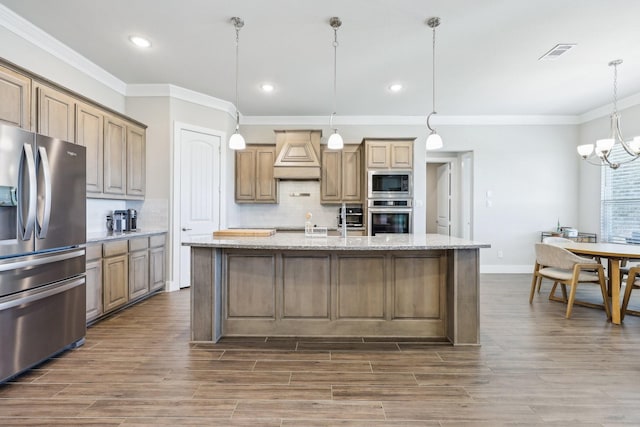 kitchen featuring wood finished floors, visible vents, custom range hood, appliances with stainless steel finishes, and backsplash