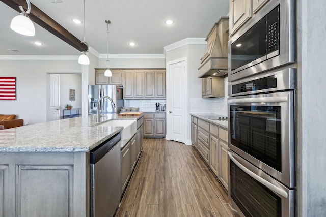 kitchen with a sink, tasteful backsplash, appliances with stainless steel finishes, custom exhaust hood, and dark wood-style flooring