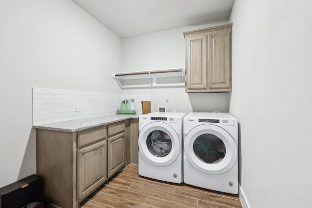 laundry room with cabinet space, independent washer and dryer, and wood tiled floor