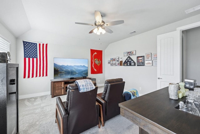 carpeted home theater with visible vents, a ceiling fan, and vaulted ceiling