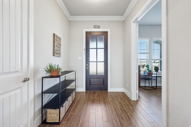 entrance foyer with baseboards, dark wood-style flooring, and crown molding