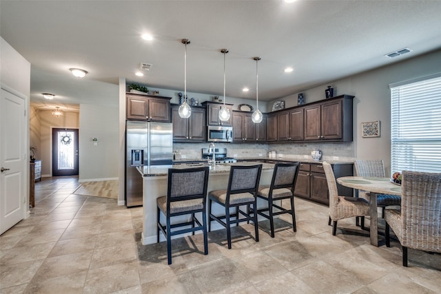 kitchen featuring decorative backsplash, dark brown cabinetry, visible vents, and appliances with stainless steel finishes