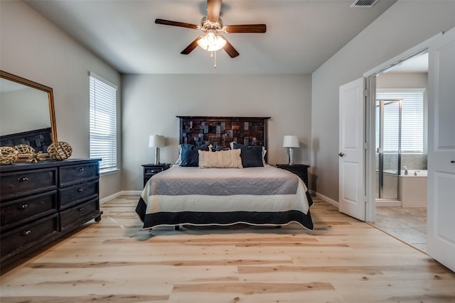 bedroom featuring visible vents, baseboards, connected bathroom, and light wood finished floors