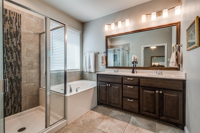 bathroom with a sink, a stall shower, double vanity, and a bath