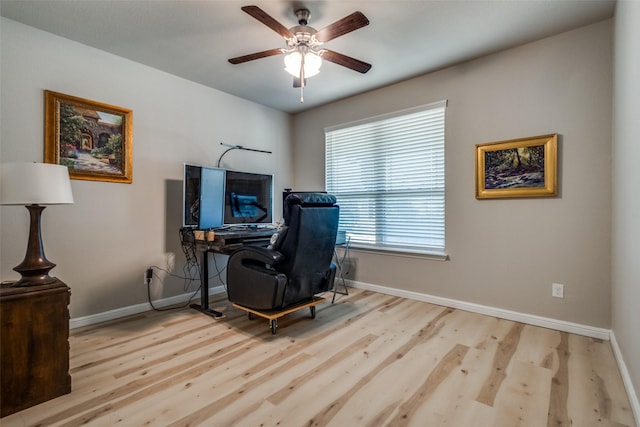 home office with baseboards, ceiling fan, and wood finished floors