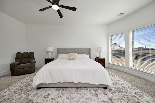 bedroom featuring visible vents, carpet flooring, baseboards, and a ceiling fan