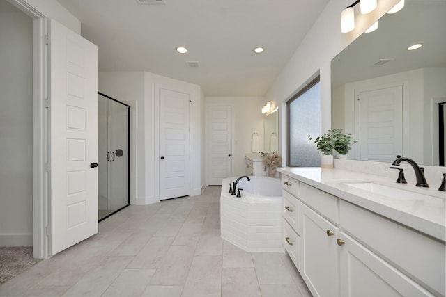 bathroom featuring vanity, a garden tub, recessed lighting, and a shower stall