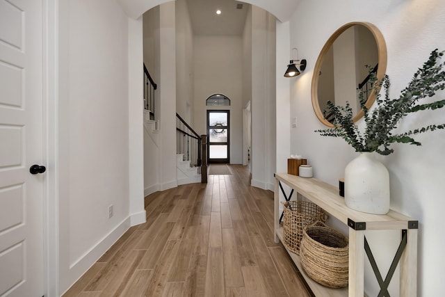 entrance foyer with stairway, recessed lighting, light wood-type flooring, and baseboards