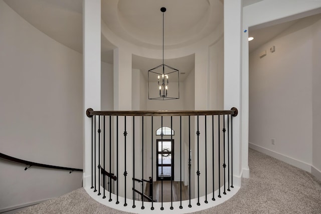 stairs with carpet, baseboards, and a chandelier