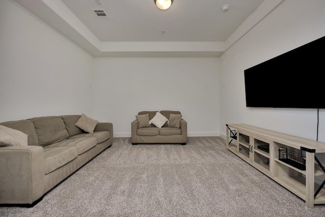 carpeted living area with baseboards and visible vents