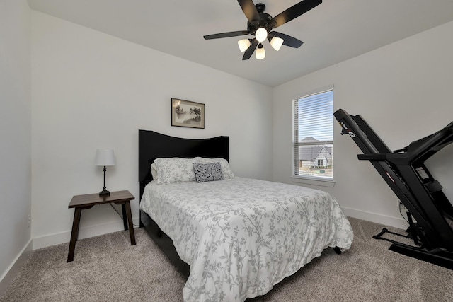 bedroom with a ceiling fan, baseboards, and carpet floors