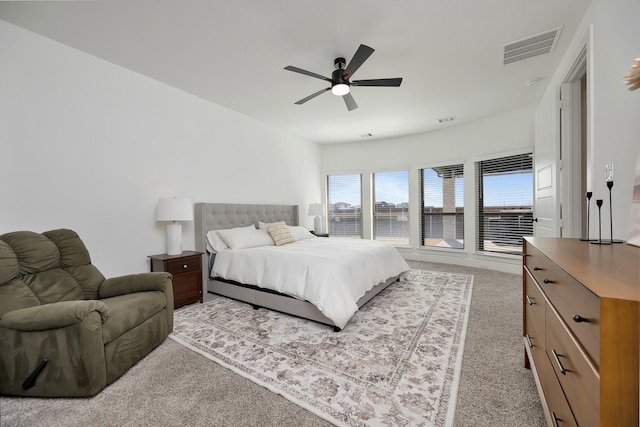 bedroom with a ceiling fan, visible vents, and light carpet