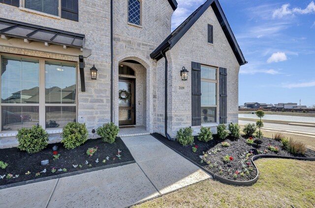 view of exterior entry featuring stone siding