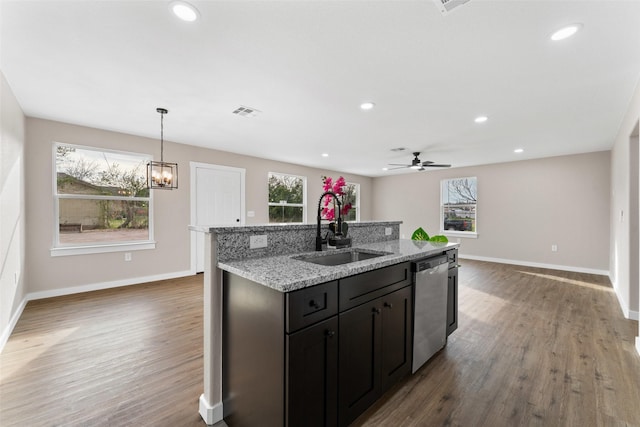 kitchen featuring visible vents, a center island with sink, a sink, wood finished floors, and dishwasher