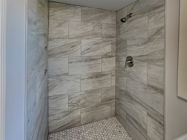 bathroom with a tile shower