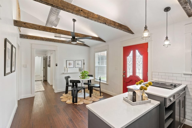 kitchen with light countertops, vaulted ceiling with beams, dark wood-type flooring, and ceiling fan