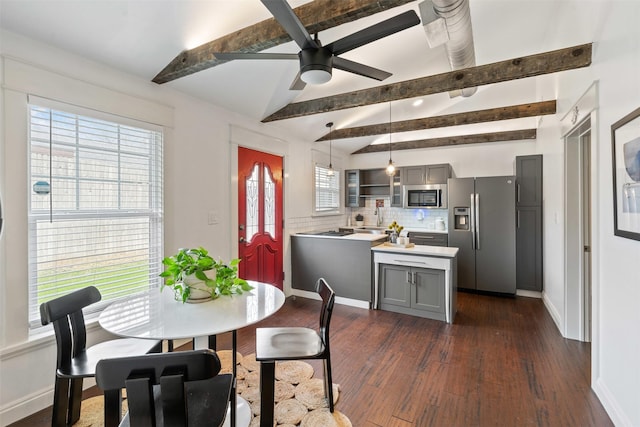 dining space with lofted ceiling with beams, baseboards, dark wood-type flooring, and ceiling fan