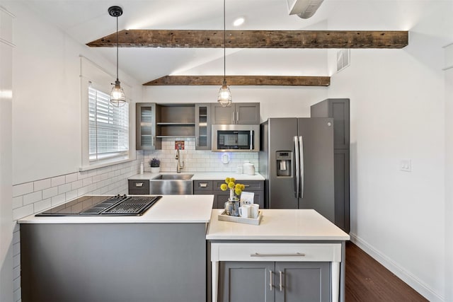 kitchen with gray cabinets, a sink, stainless steel appliances, decorative backsplash, and vaulted ceiling with beams