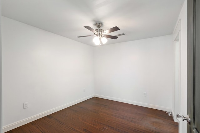 unfurnished room with visible vents, baseboards, dark wood-type flooring, and a ceiling fan