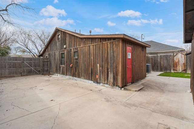 view of outbuilding with an outbuilding, fence, and central AC