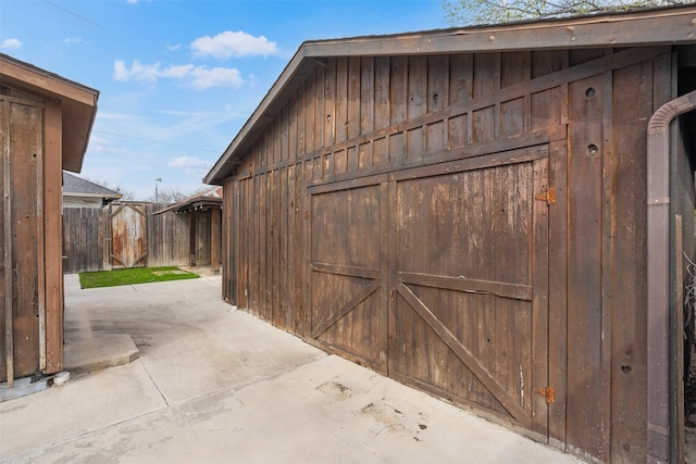 view of outbuilding with an outbuilding and fence