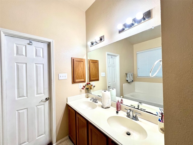 full bath featuring a bath, double vanity, and a sink