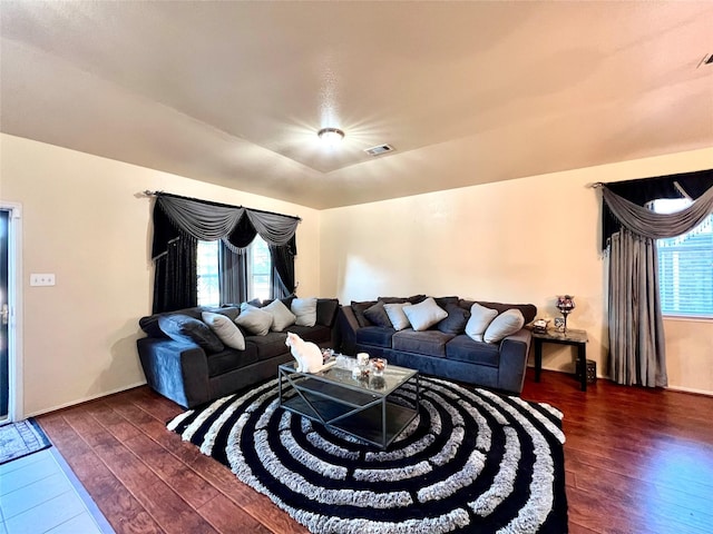 living room with visible vents and dark wood-type flooring