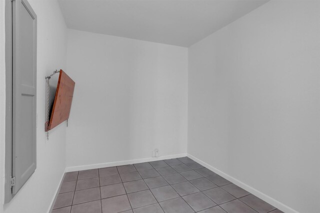 tiled empty room with baseboards