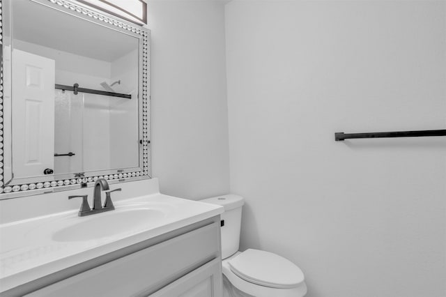 full bathroom with a shower, vanity, and toilet