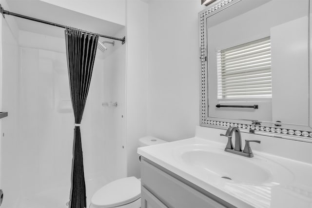 full bathroom with toilet, a shower stall, and vanity