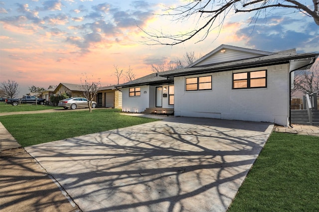 view of front of house with a garage, a front yard, and driveway