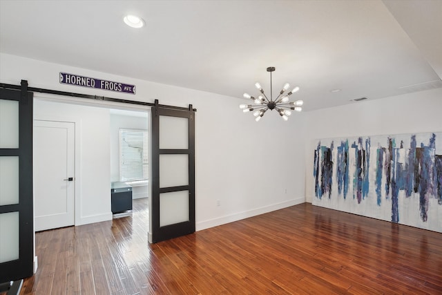 8917 Random Rd, Fort Worth, TX 76179 - unfurnished room with wood finished floors, visible vents, a barn door, and a notable chandelier